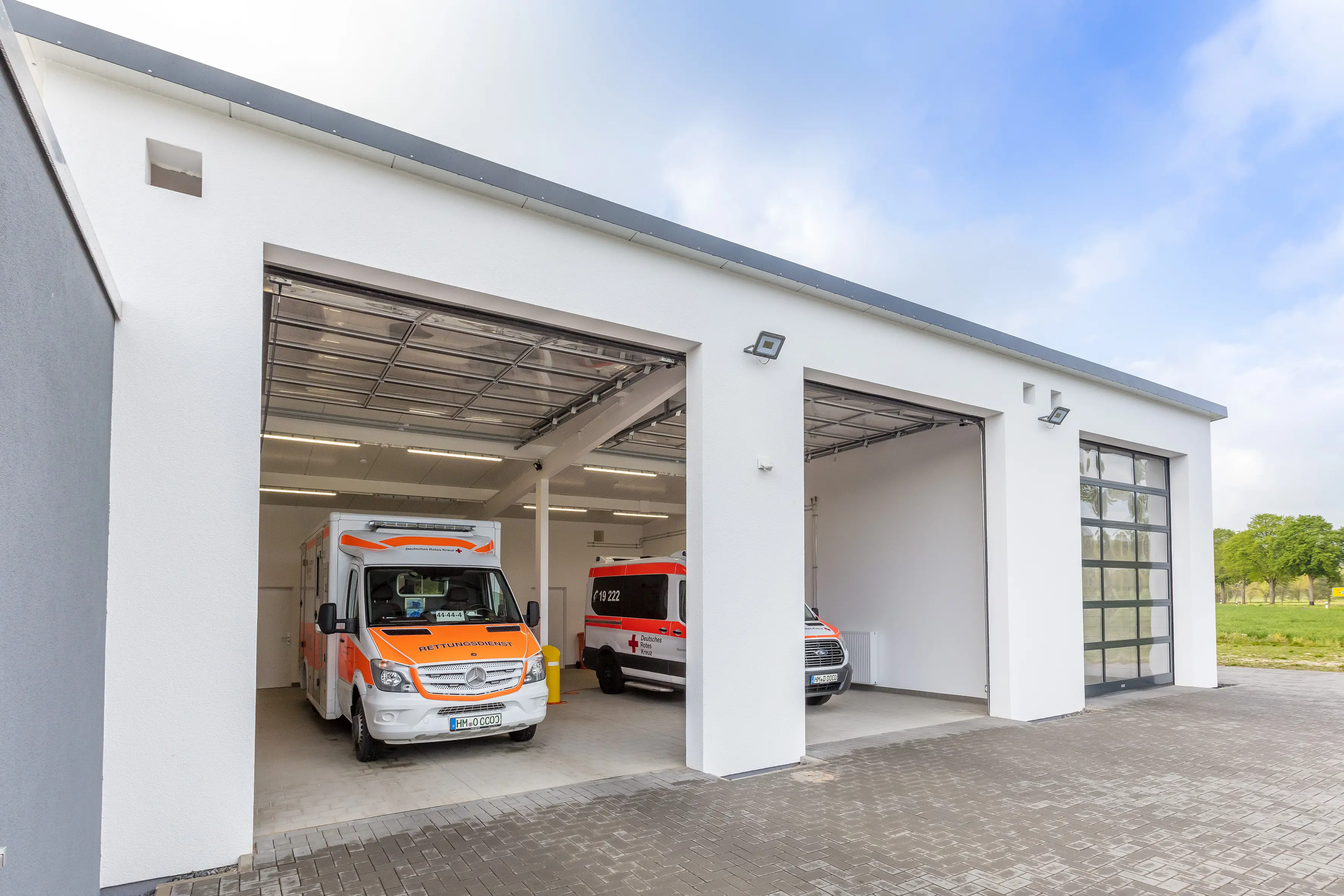 Rettungsfahrzeug der DRK vor Fahrzeughalle in Aerzen Rettungswache DRK in Aerzen - Fahrzeughalle